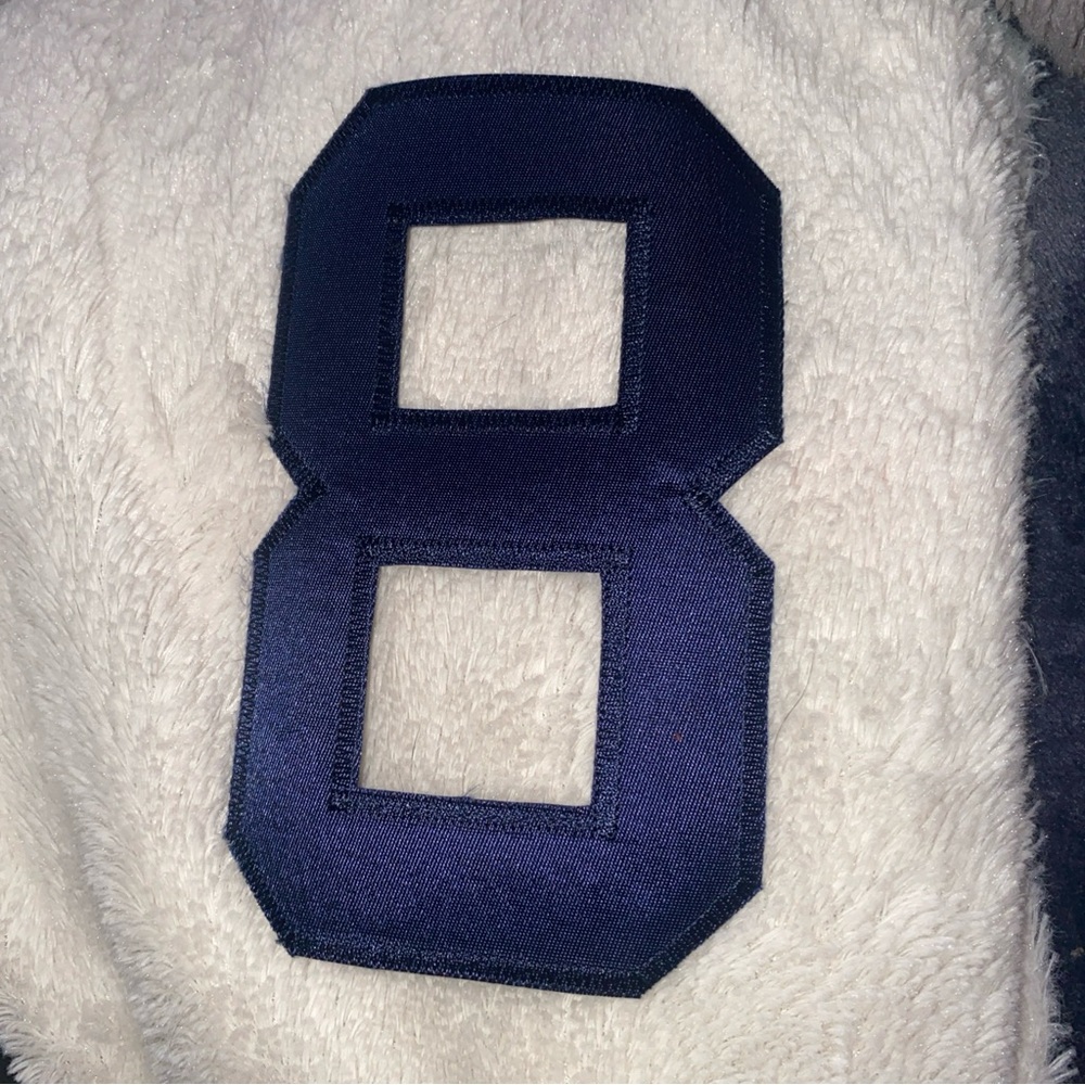 number "8" patch,  an embroidered or iron-on patch.